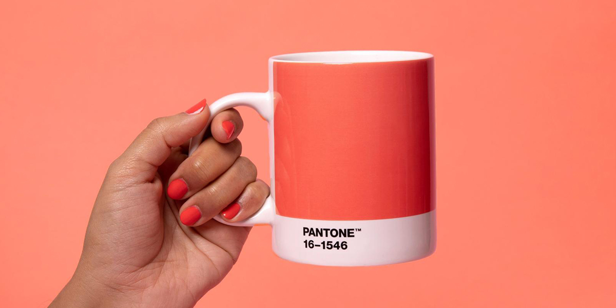 Pantone color of the year 2019 on a mug with living coral background.